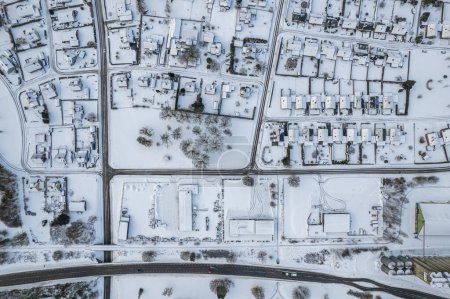 Photo for Aerial view of residential area in Sweden with low-rise and private buildings during winter. Snowy weather, snowfall in a little European village, town, city. - Royalty Free Image