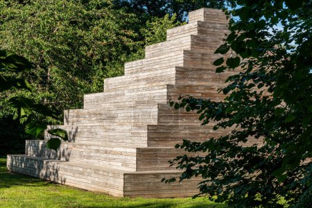 A big and creative wooden pyramid outdoors, modern public space, meeting place, recreational area