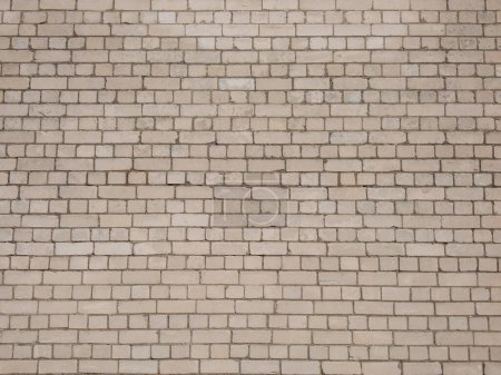 View of empty, white brick wall background with copy space. A deteriorating brick wall outdoors in bright sunlight