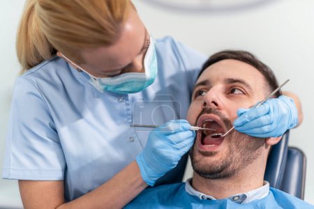 Photo for Woman dentist at work with patient.Dental care,taking care of teeth. - Royalty Free Image