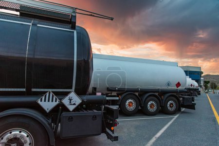 Photo for Rear of several parked dangerous goods tankers where the danger labels can be seen. - Royalty Free Image
