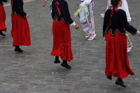 Photo for Basque folk dancers during a performance in a street festival - Royalty Free Image