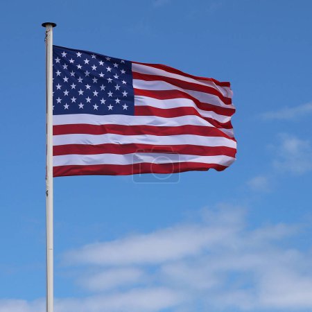 Photo for An American flag flaping boldly in the wind. - Royalty Free Image