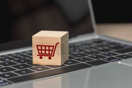 Photo for Wood cube block with shopping cart icons on keyboard laptop, online shopping concept. connection marketplace consumer service. - Royalty Free Image