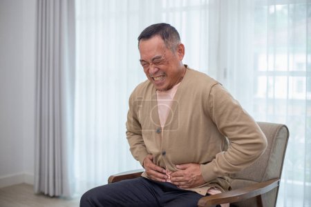 Photo for Asian elderly senior man problem stomach ache. Health problems of the elderly Body pain, congenital disease, waist pain. Retirement unhealthy and stress. - Royalty Free Image