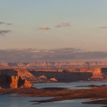 Spectacular view of rocky formations of Glen Canyon located near river under bright sundown sky in Colorado