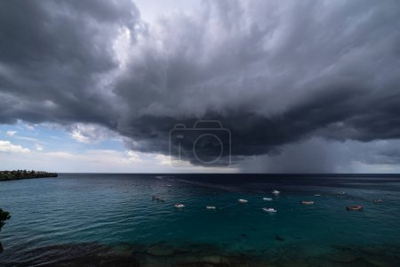 Photo for Thundershower scenery with flying clouds over the turquoise sea around Curacao, the Caribbean - Royalty Free Image