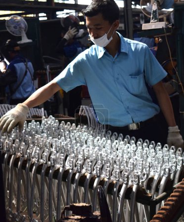 Photo for SIDOARJO, INDONESIA - APRIL 9, 2015: Worker checking on the assembly line at the assembly bicycle from Indonesia Polygon in Sidoarjo, East Java, Indonesia - Royalty Free Image