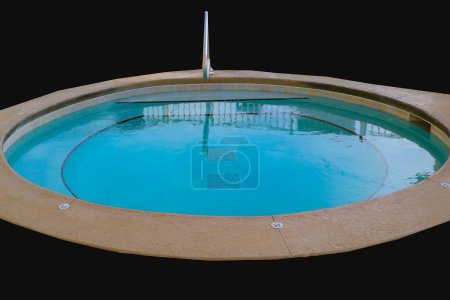 Photo for An in-ground hot tub, nestled in black background, beckons relaxation in stylish isolation. - Royalty Free Image