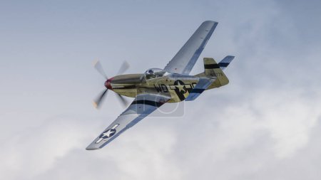 Photo for Cosford,UK - 12th June 2022: A Consolidated P51 Mustang fighter aircraft of world War Two vintage, in flight against a blue sky. Close up shot - Royalty Free Image