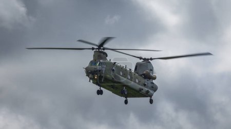 Photo for Cosford, UK - 12th June 2022: A Boeing Chinook military helicopter of the RAF hovers close to the ground - Royalty Free Image
