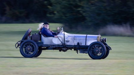 Photo for Old Warden, UK - 2nd October 2022: Vintage car 1911 Sunbeam 12/16 being driven at speed along a grass runway - Royalty Free Image