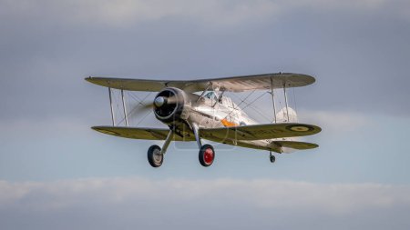 Photo for Old Warden, UK - 2nd October 2022:  Vintage aircraft 1937 Gloster Gladiator flying close to the ground - Royalty Free Image