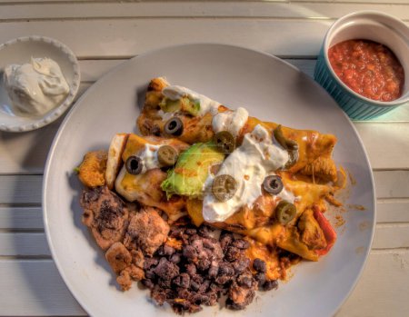 Photo for Top View of Chicken Enchiladas on white Natural wood surface - Royalty Free Image