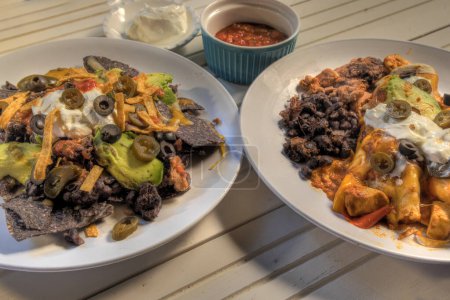 Photo for Side view of nachos and Chicken Enchikadas - Royalty Free Image