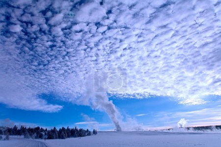 Brunnen-Geysir produziert viel Dampf, um den Himmel über im Winter im Yellowstone-Nationalpark zu beeinflussen