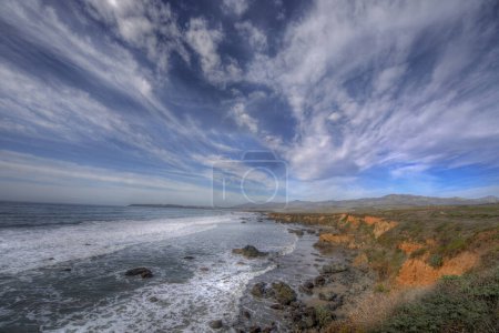 Waves crash along the coastline near San Simeon, California.