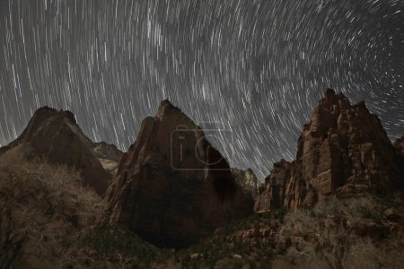 Star Trails appear at The Courth Of The Patriarchs at Zion National Park, Utah