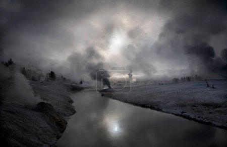 Steam from hot springs and geysers rise along the Firehole River at Yellowstone National Park, Wyoming