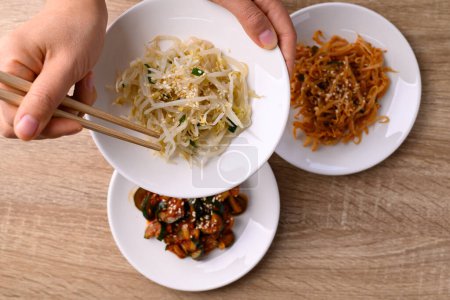 Photo for Korean side dish, Mung bean sprouts salad and kimchi cucumber, Table top view - Royalty Free Image