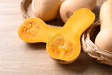Photo for Butternut squash pumpkin in basket on wooden table, Organic vegetable in autumn season - Royalty Free Image
