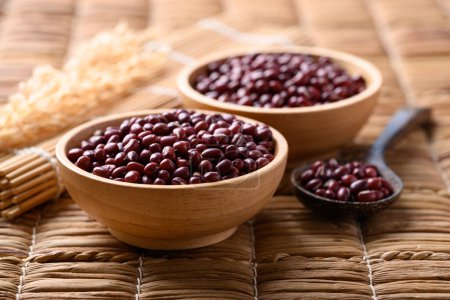 Red mung bean or Azuki bean in wooden bowl with spoon, Food ingredients
