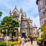 Da Nang, Vietnam - 12 Aug 2022: Many tourists on European style streets in Ba Na Hills Mountain Resort with amusement rides, attractions, restaurants.The famous tourist destination in Da Nang