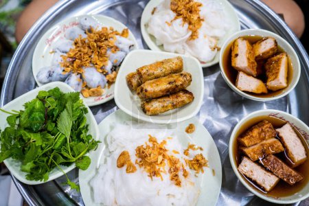 Photo for Banh cuon - Vietnamese steamed rice rolls with minced meat inside accompanied by bowl of fish sauce. Detail. Selective focus. - Royalty Free Image