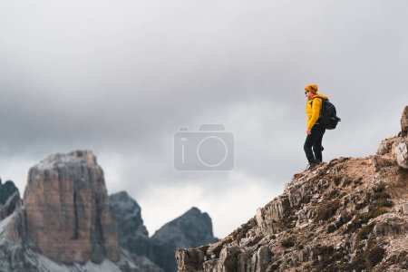 Photo for Active climber on top of mountain. enjoying the view. Hiker winning reaching life goal, succes, freedom and happiness, achievement in mountain, Dolomites, Italy - Royalty Free Image