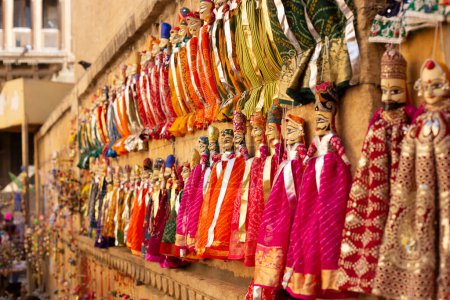 Photo for Colorful traditional handmade puppet dolls of India being sold at a street side shop at Jaisalmer, Rajasthan - Royalty Free Image