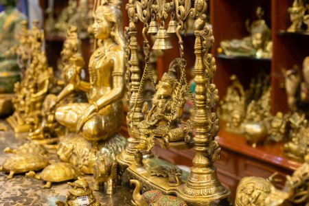 Messing-Idol von Lord Ganesha zusammen mit anderen Statuen, die in einem indischen Marktladen verkauft werden