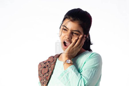 An Indian woman facing teeth problem showing painful expression on white background