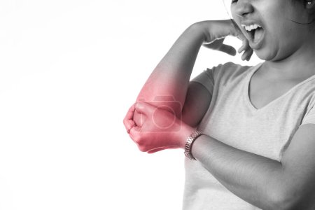 An Indian woman holding her elbow for pain showing painful expression on white background