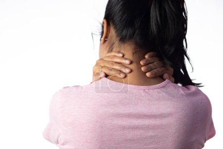 An Indian woman holding her neck for pain showing painful expression on white background
