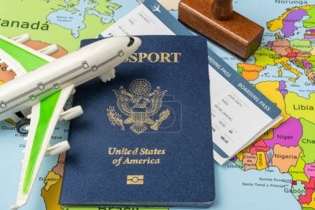Photo for United States passport, stamp, airplane and boarding pass on a map of the world. Business trip. Holiday and adventure. Documents required for travel - Royalty Free Image