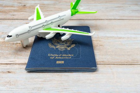 Photo for US passport and stamp on wooden background. Safe journey with necessary documentation. Top view. Copy space. Your Key to International Travel - Royalty Free Image