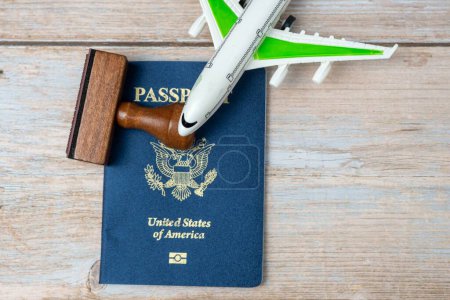 Photo for US passport and stamp on wooden background. Safe journey with necessary documentation. Top view. Copy space. Your Key to International Travel - Royalty Free Image