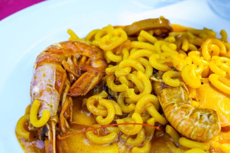 Photo for Fideu,fideuada, a dish originating in Ganda, Valencian Community, Spain that is made similarly to paella, although based on noodles instead of rice - Royalty Free Image