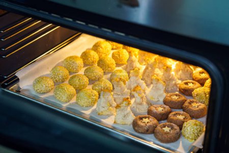 Photo for Panellets, a traditional sweet from Catalonia, Spain, prepared to be eaten on November 1, All Saints' Day. Sweet dough made with sugar, ground raw almonds, egg, sugar, sugared almonds, egg. - Royalty Free Image