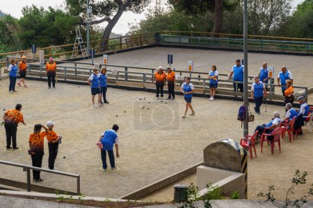 Photo for Barcelona, Spain-October 8, 2023. Group of women playing ptanque, a sport/game of French origin in which the objective is to throw balls as close to the bowling alley as possible.. - Royalty Free Image