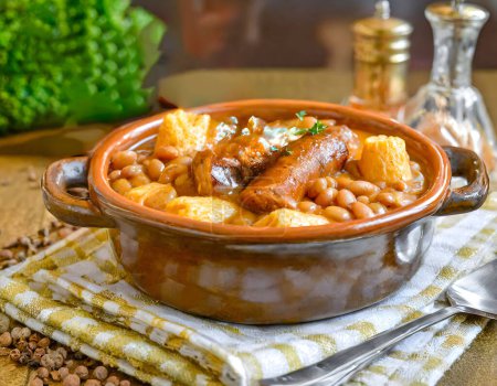 French Cassoulet. Hearty French sausage and bean stew with a crispy breadcrumb topping.