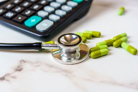 Stethoscope, Pills, and Calculator on Table. Medical, Healthcare, Finance