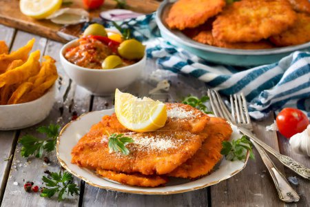 A traditional Austrian Wiener Schnitzel served with fresh ingredients, capturing the essence of Austrian cuisine.