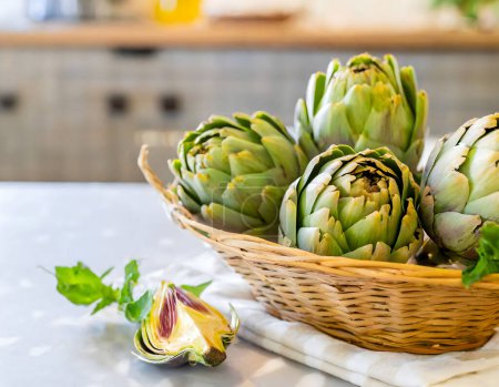 Photo for A basket of fresh green artichokes on a wooden board, portraying natural and healthy living - Royalty Free Image