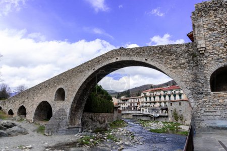 Photo for Girona, Spain - March 29, 2024. The river Ter passes through the medieval village of Camprodon with its ancient stone bridge. Girona, Spain - Royalty Free Image
