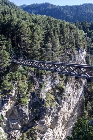 Summer view of the Devils bridge (Pont du diable) above the Arc Gorge in the French alps. This travel destination is situated near Modane in the Vanois National Park of Savoie in France.  