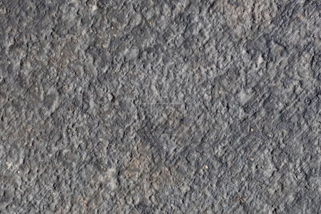 Foto de Fondo de textura abstracta de marco completo de una superficie de calle de asfalto, con textura natural y decoloración del clima y la edad - Imagen libre de derechos