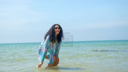 Téléchargez les photos : Les jeunes femmes jouent à la mer pendant leurs vacances d'été et elles sourient et sont heureuses en vacances - en image libre de droit