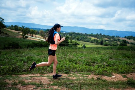 Photo for Young women active trail runners the top of a mountain in the afternoon, ultra marathon runners adventuring outdoors - Royalty Free Image