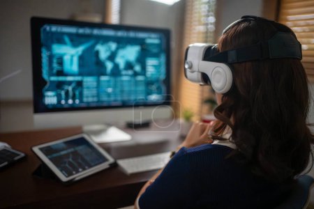 Foto de Mujeres futuristas Ingenieras que usan gafas de realidad virtual trabajando con un holograma futurista para analizar y crear soluciones de energía alternativa con turbinas eólicas - Imagen libre de derechos